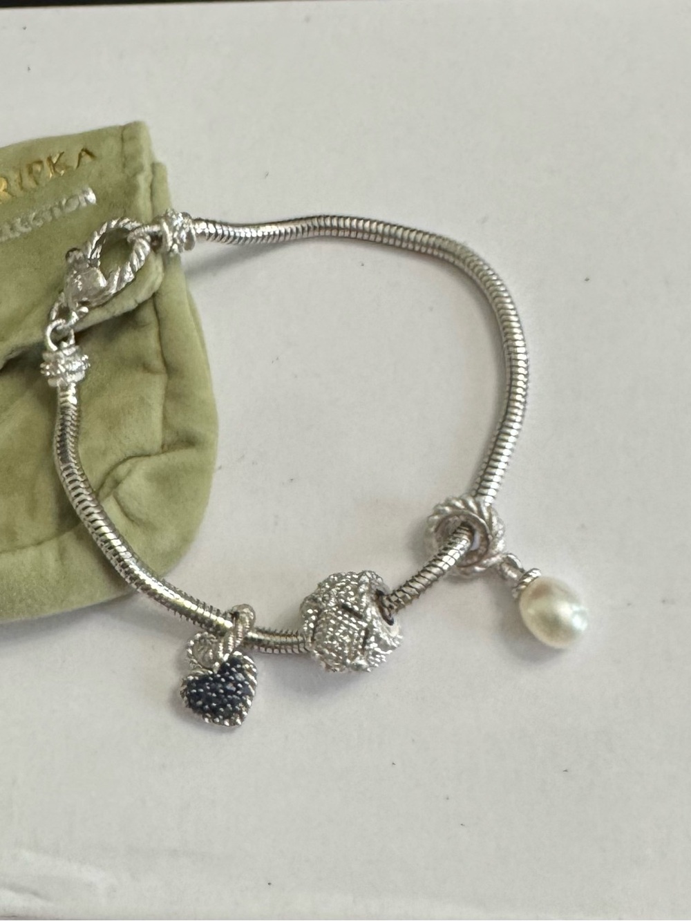 J Ripka 925 Silver Charm Bracelet w/White Pearl, Blk Heart & Crystal Barrel Chms